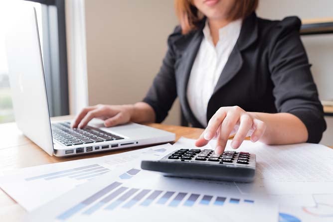 women working in an office setting and doing accounting 